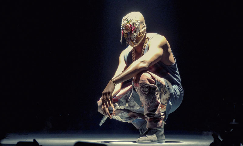 kanye squating with mask on